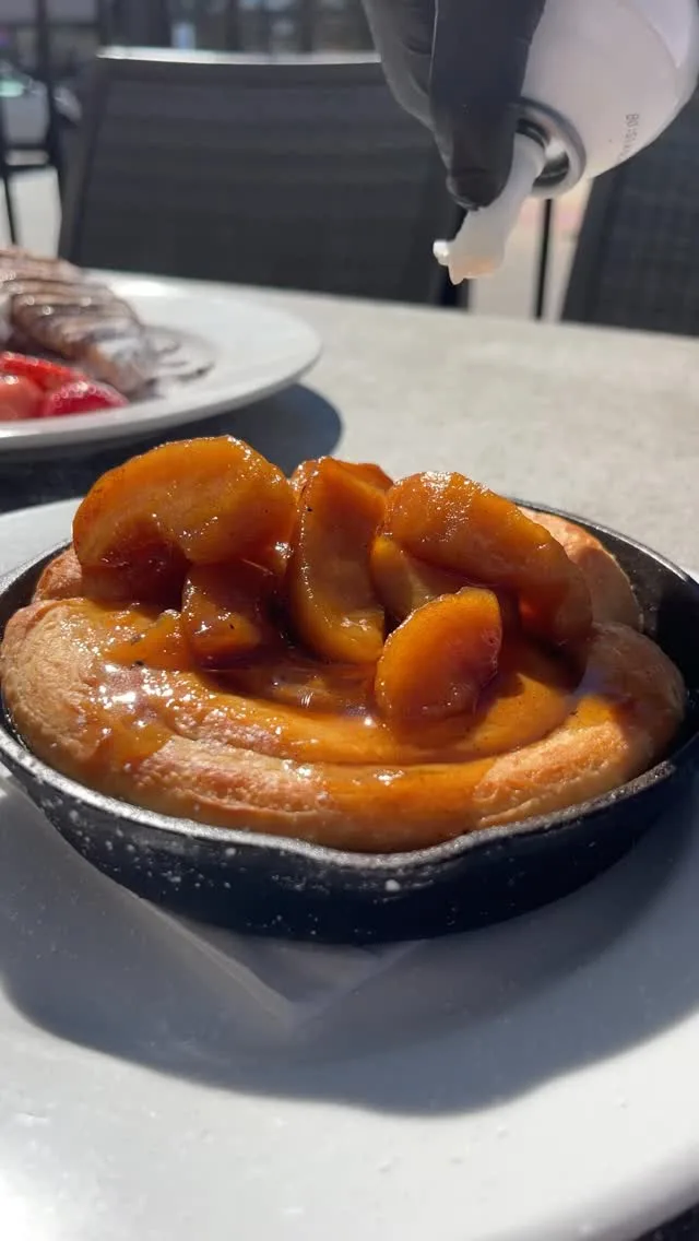 Whipped cream is the perfect finishing touch on our Bourbon Apple Cinnamon Rolls. Sweet, cozy, and only here for a limited time at Wild Eggs 🍁